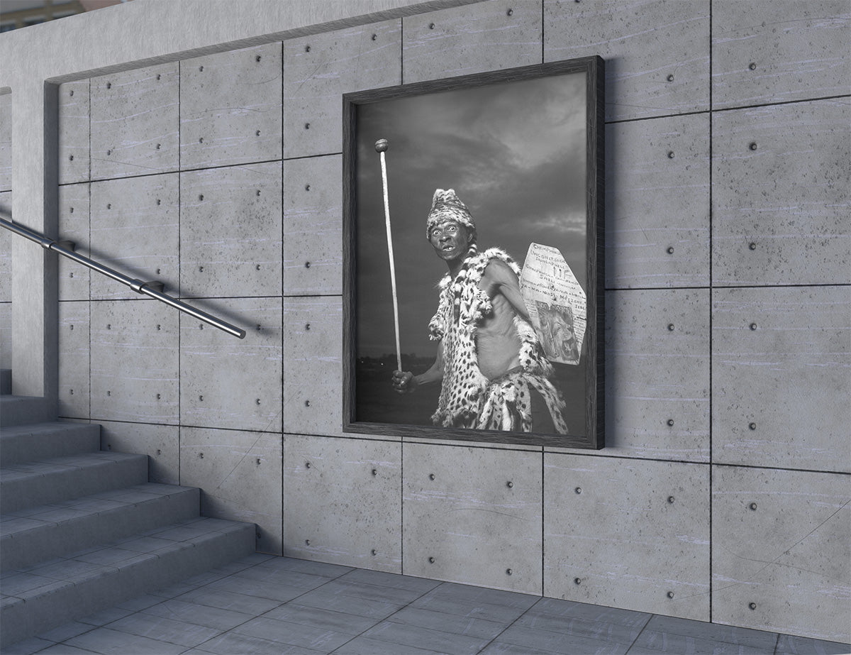 Framed black and white portrait on a concrete wall with stairs in the foreground